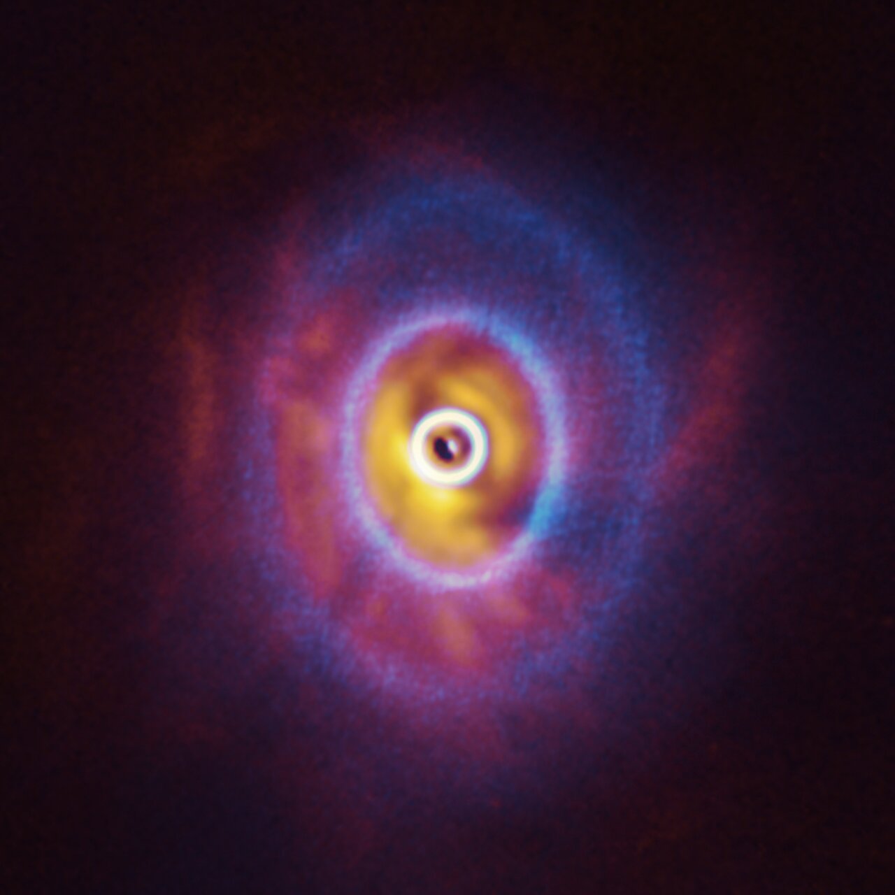 Blue rings superimposed over an orange and red blur. At the center, there is a bean-shaped gap.